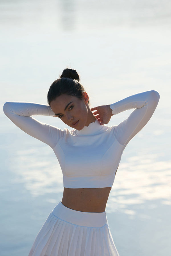 Model wears WISKII Open Back Long Sleeve Crop Top