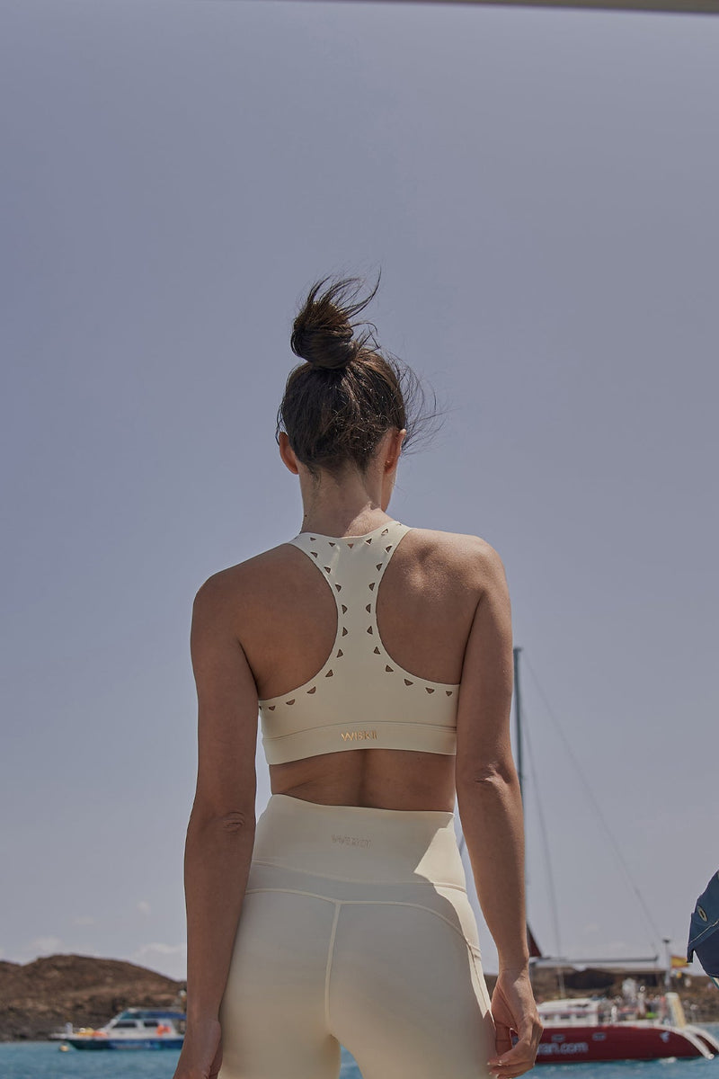 Model wears Racerback Laser Cut Sports Bra + V-Waist Vigorous Short | WISKII