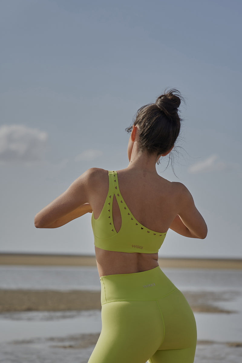 Model wears WISKII One-shoulder Laser Cut Sports Bra | WISKII ACTIVE