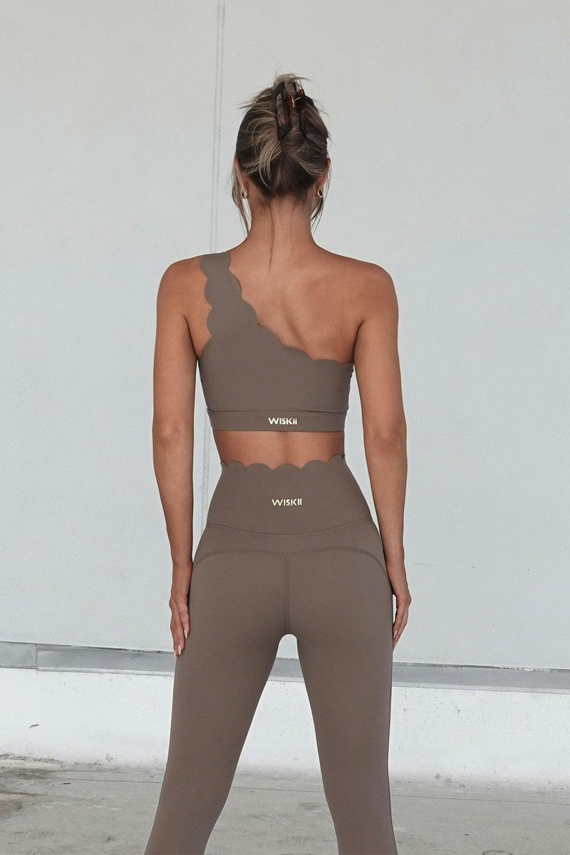 Model wears Dynamic One Shoulder Sports Bra + 7/8 High-Waist Energy Legging | WISKII