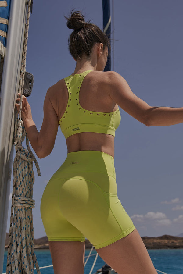 Model wears WISKII Racerback Laser Cut Sports Bra