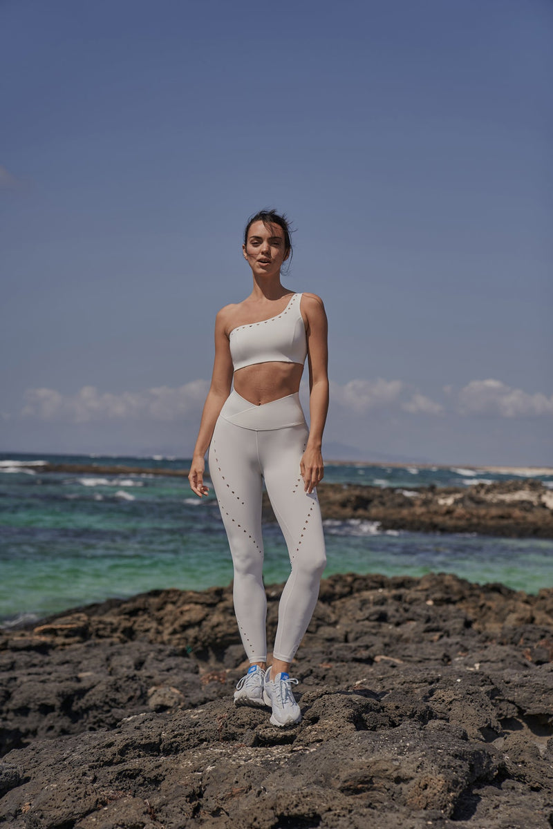 Model wears One-Shoulder Laser Cut Sports Bra + V-Waist Laser Cut Sports Legging | WISKII 