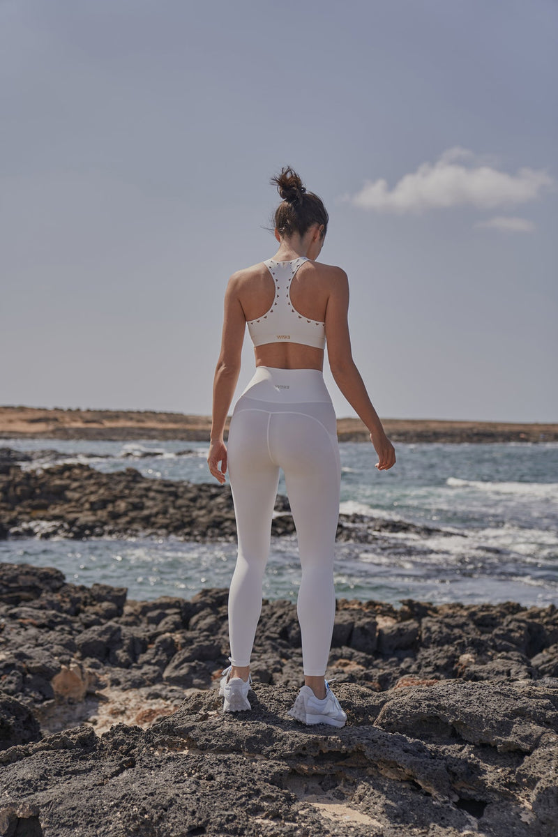 Model wears Racerback Laser Cut Sports Bra + V-Waist Utility Legging | WISKII