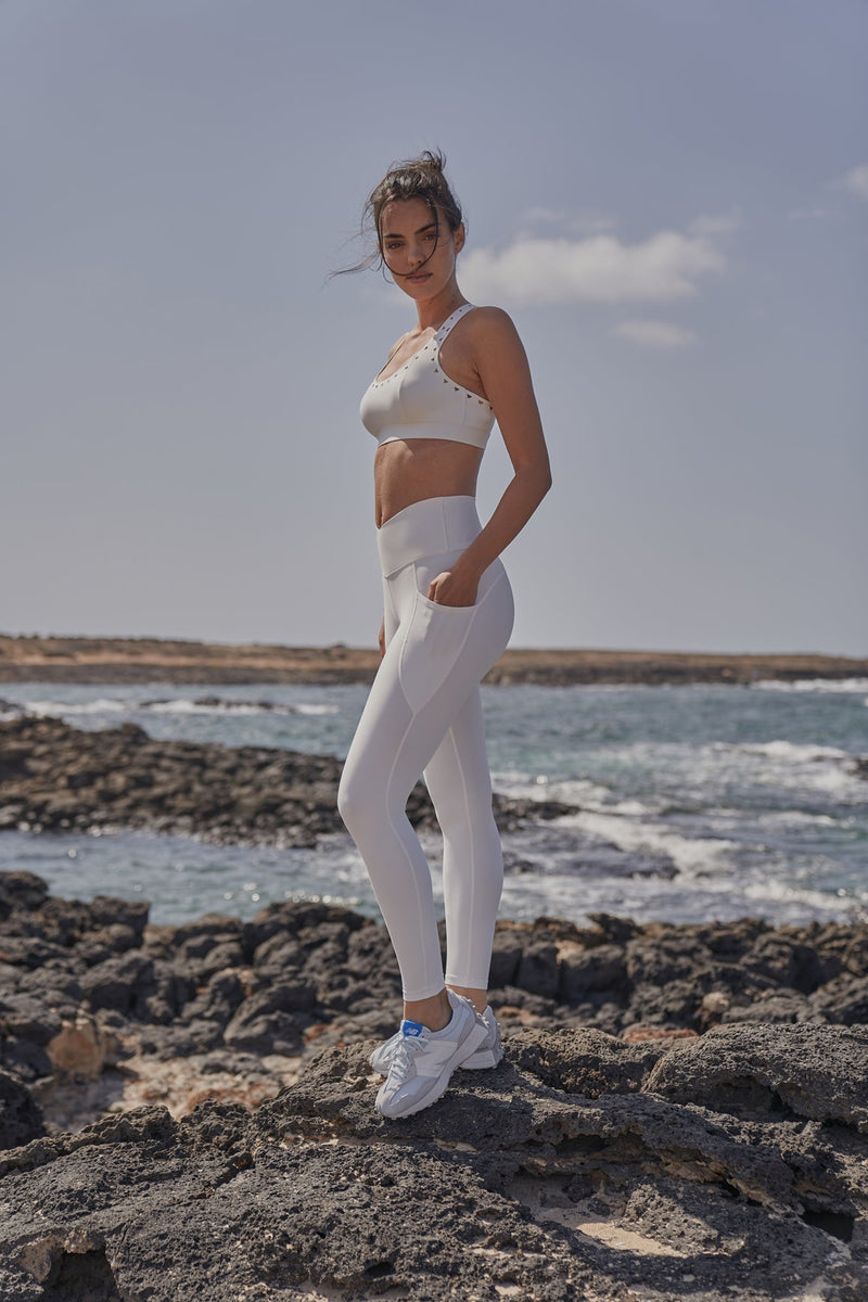 Model wears Racerback Laser Cut Sports Bra + V-Waist Utility Legging | WISKII