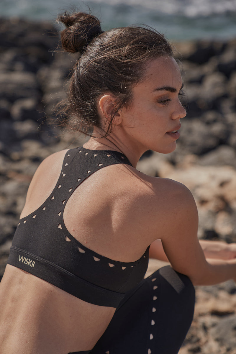 Model wears WISKII Racerback Laser Cut Sports Bra