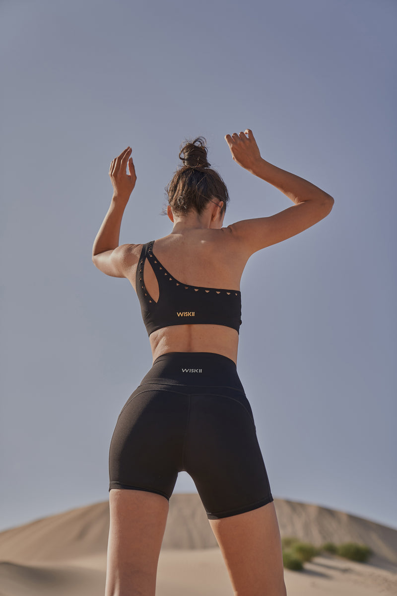 Model wears WISKII One-shoulder Laser Cut Sports Bra | WISKII ACTIVE