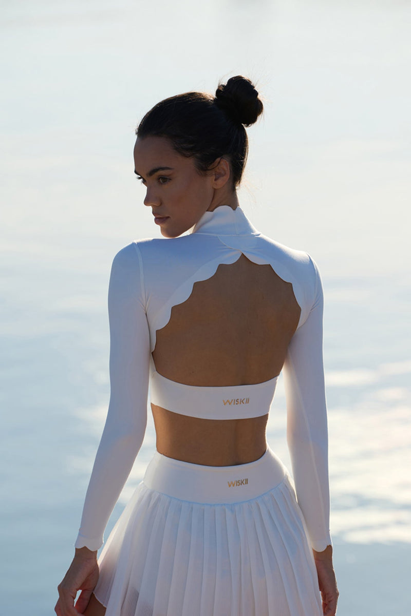 Model wears WISKII  Open Back Long Sleeve Crop Top