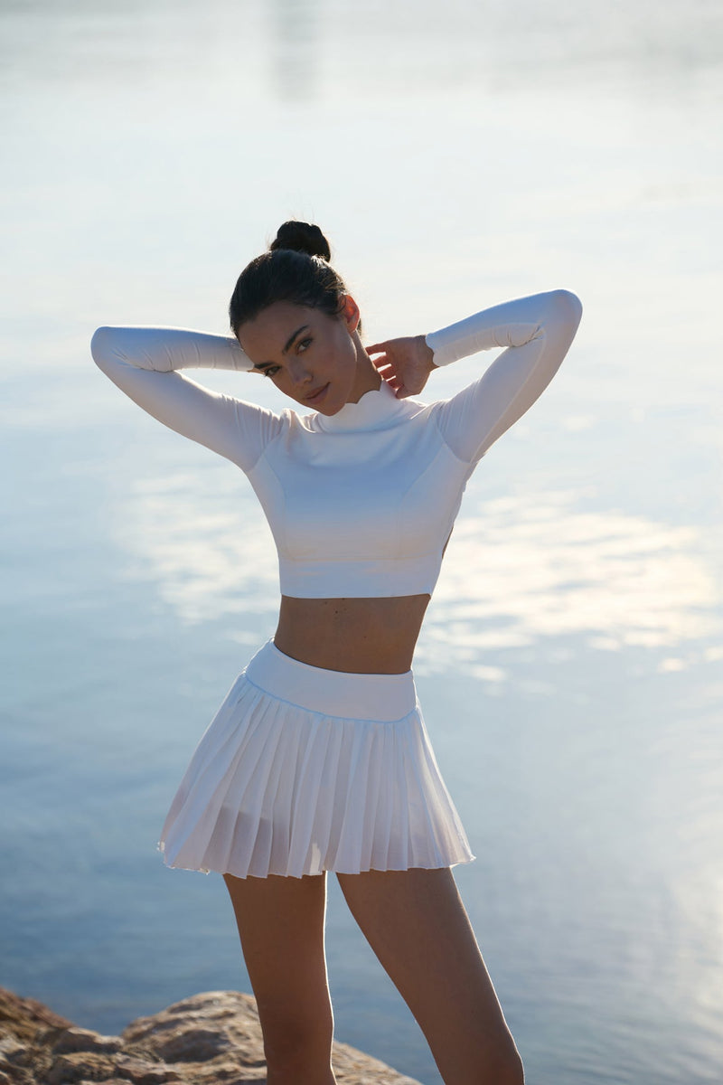 model wears a WISKII Lite Pleated Skirts