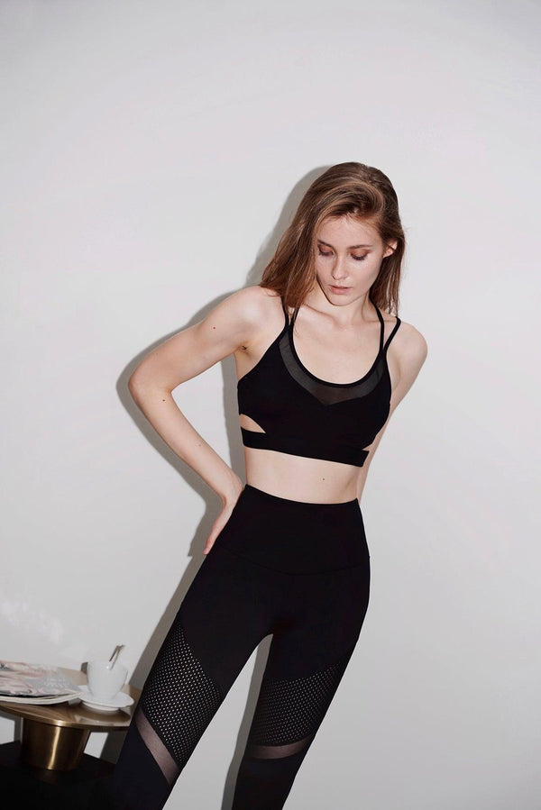 model waers a color black wiskii strappy sports bra