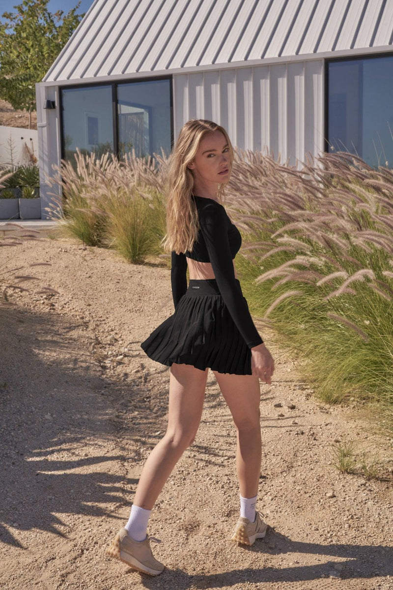 model wears a WISKII Lite Pleated Skirts