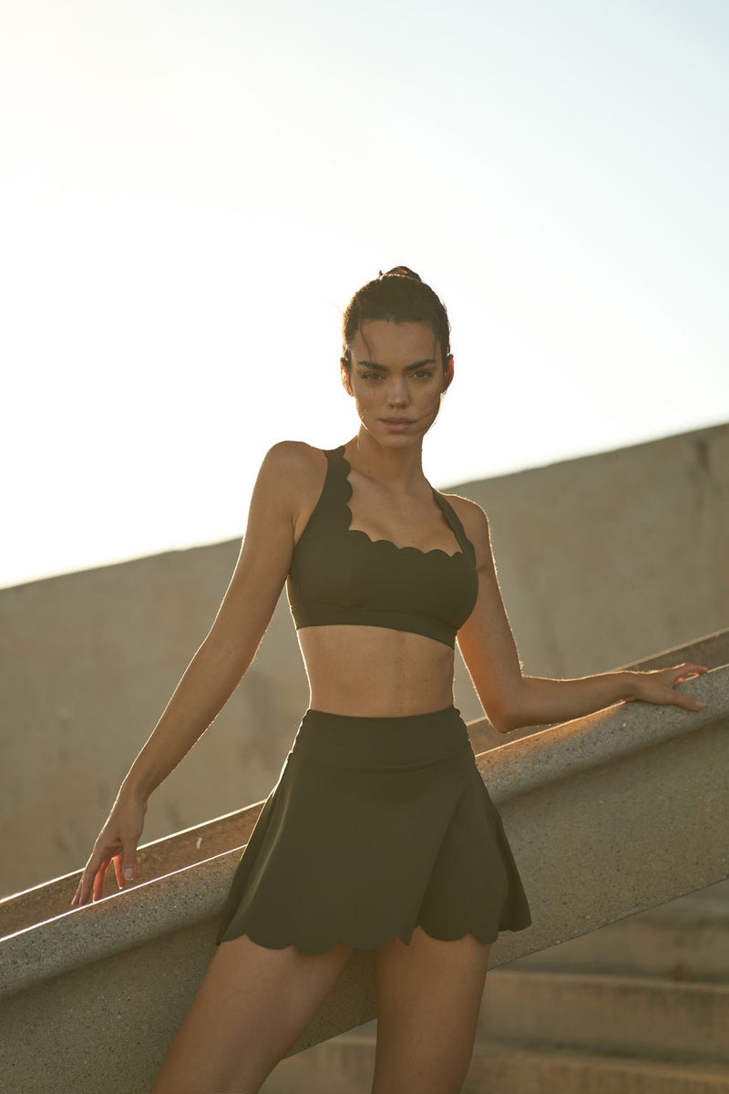 Model wears WISKII high waist a line tennis skirt