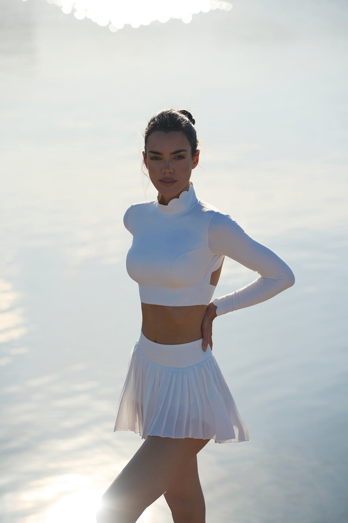 model wears a WISKII Lite Pleated Skirts