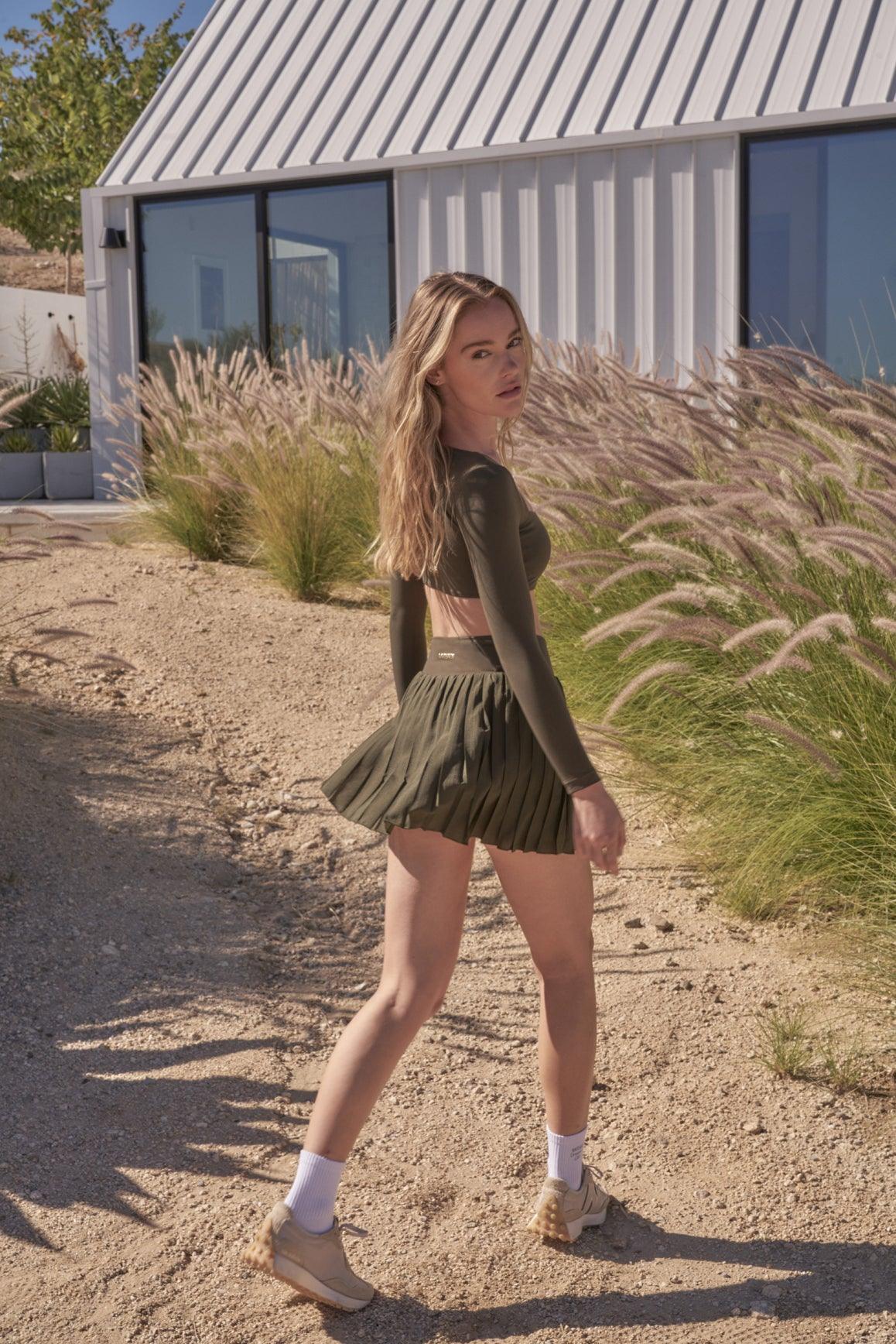 model wears a WISKII Lite Pleated Skirts