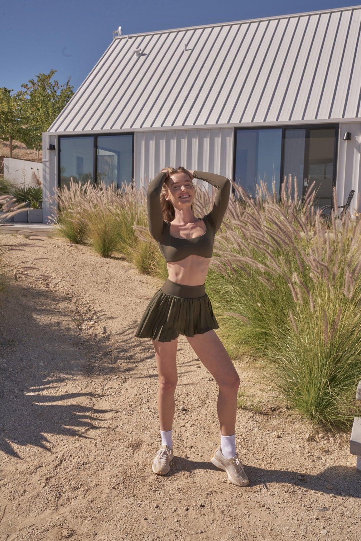 model wears a WISKII Lite Pleated Skirts